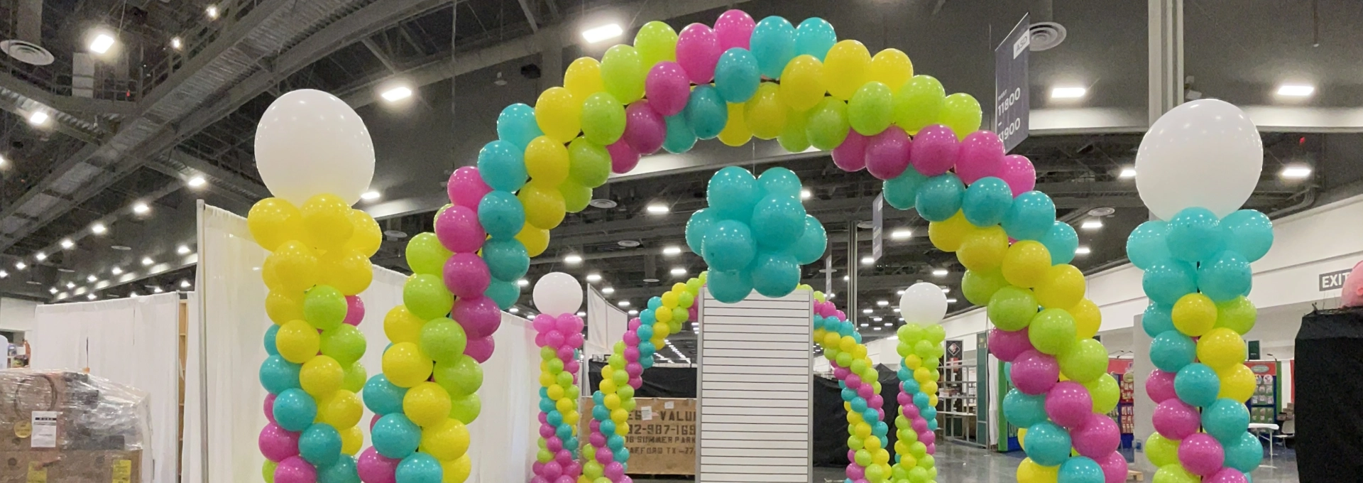 Colorful balloon arches in exhibition hall.