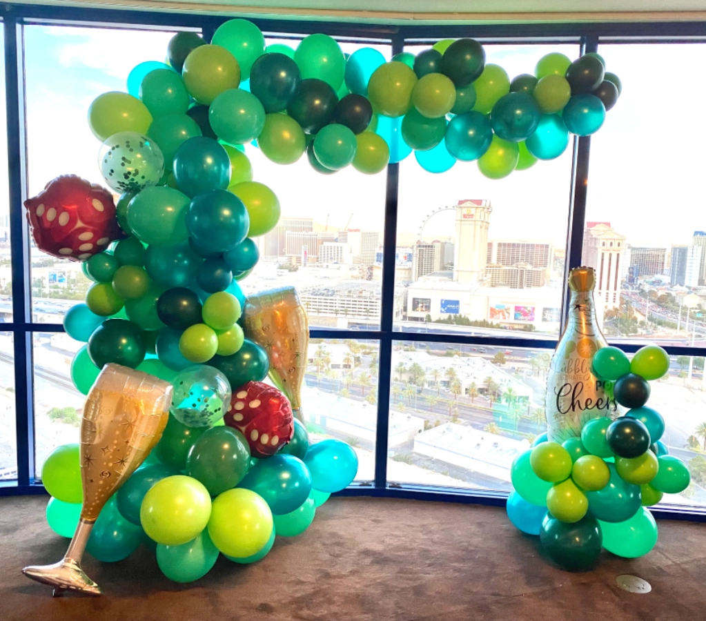 Colorful balloon display with champagne decorations.