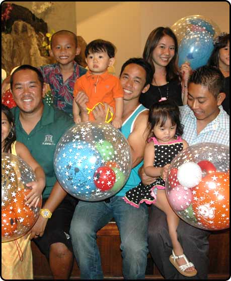 Group of people holding colorful star balloons.