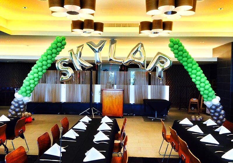 Balloon letters "SKYLAR" in decorated room.