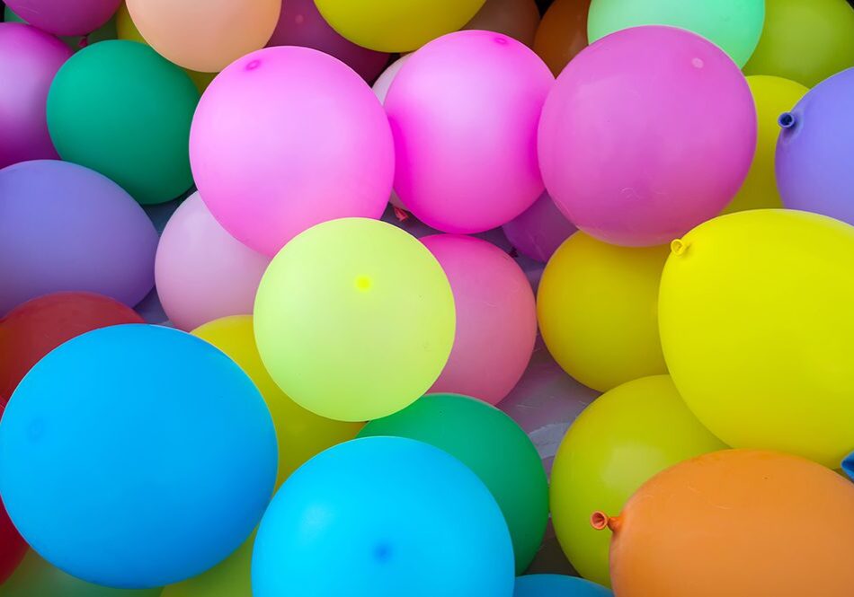 Colorful balloons clustered together in celebration.