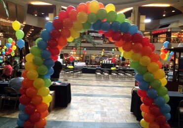 Colorful balloon arch in a shopping mall.